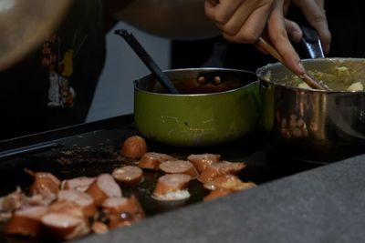 Midsection of man preparing food in kitchen