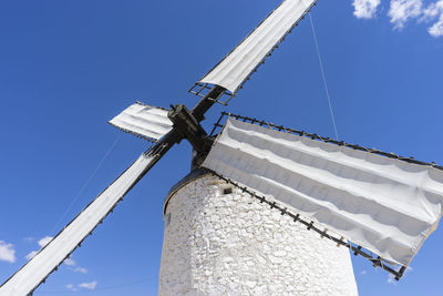 Low angle view of traditional windmill against clear blue sky