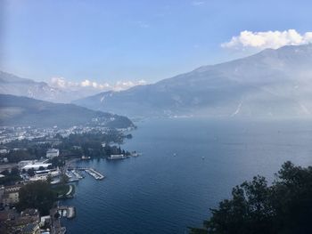 Aerial view of townscape by sea against sky