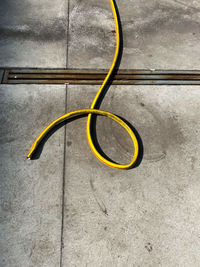 High angle view of yellow cables on metal