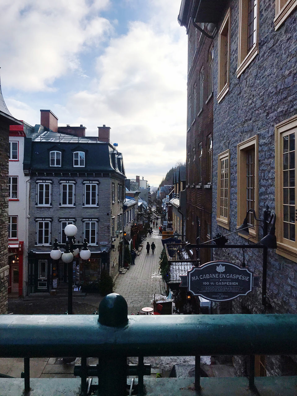 BUILDINGS BY STREET AGAINST SKY