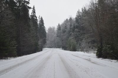 Road passing through snow covered landscape