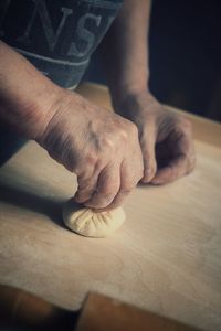 Midsection of person making dumpling