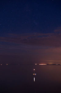 Scenic view of sea against sky at night