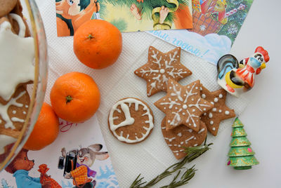 High angle view of cookies and christmas decorations on table