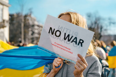 Woman at pro ukraine rally holding banner