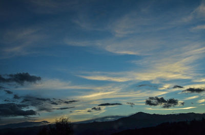 Low angle view of silhouette mountain against sky at sunset