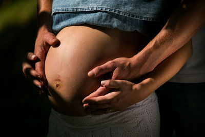 Midsection of man touching woman