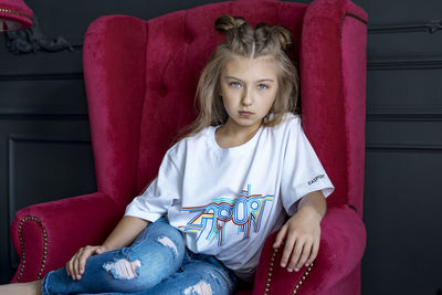 Portrait of girl sitting on seat