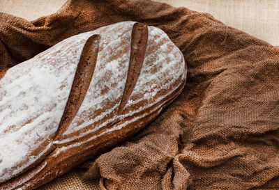 Loaf of rye bread on rustic background with copy space