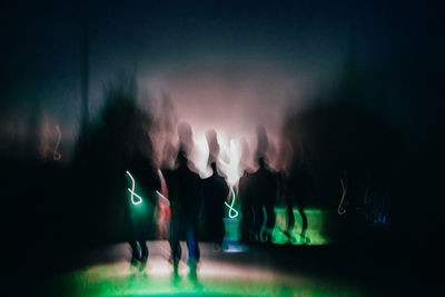 People enjoying music concert at night