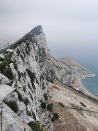 High angle view of rocks by sea against sky