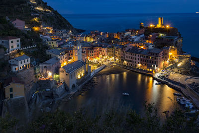 High angle view of illuminated buildings in city at night