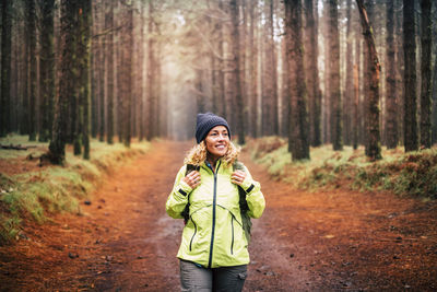 Young woman standing in forest