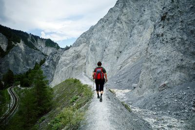 Rear view of man walking on mountain