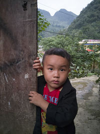 Portrait of cute boy standing outdoors