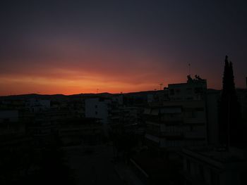 Silhouette buildings against sky during sunset