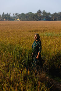 A beautiful caucasian girl in an indian dress meditates and greets the sunrise