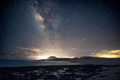 Scenic view of sea against sky at night