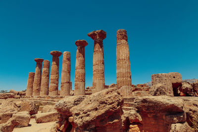 Low angle view of old ruins against blue sky