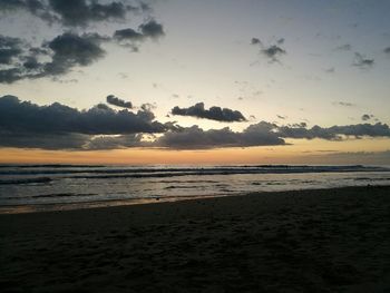 Scenic view of beach against sky during sunset