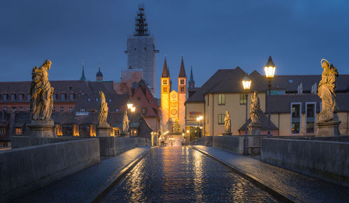 Illuminated buildings in city against sky at night