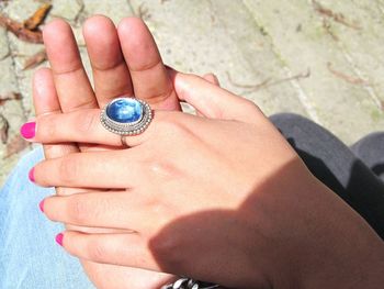 Cropped image of hand holding ring