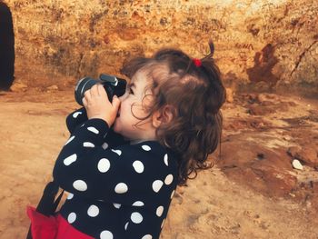 Little girl holding camera