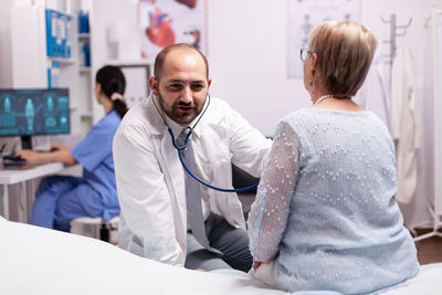 Doctor examining patient in clinic