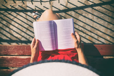 Low section of woman reading book