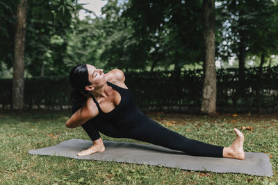 Fitness instructor exercising skandasana pose in park