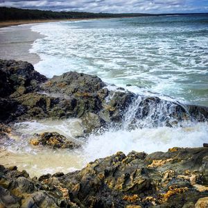 Waves splashing on rocks at shore