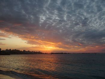 Scenic view of sea against romantic sky at sunset