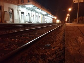 Railroad tracks in city at night