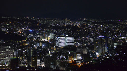 High angle view of illuminated city buildings at night