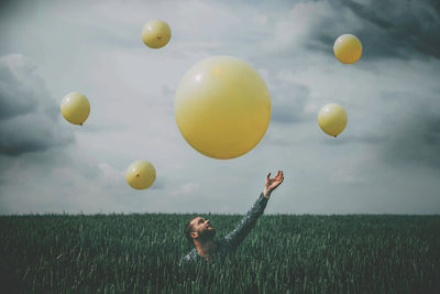 Man standing on field against sky