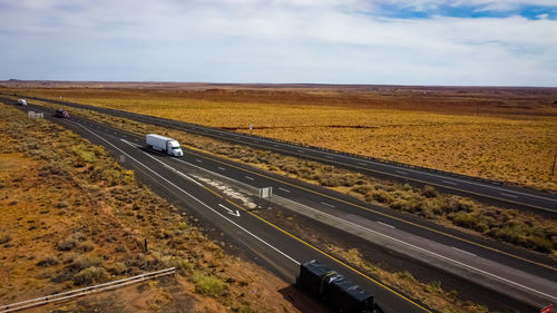 High angle view of railroad tracks on road against sky