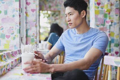 Young man sitting on table
