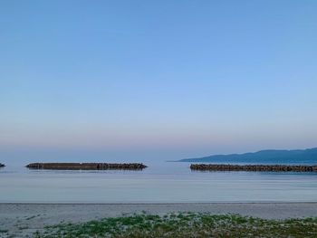 Scenic view of sea against clear blue sky