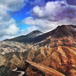 Scenic view of mountains against cloudy sky