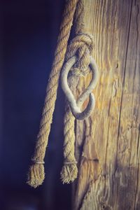 Close-up of rope tied on wood