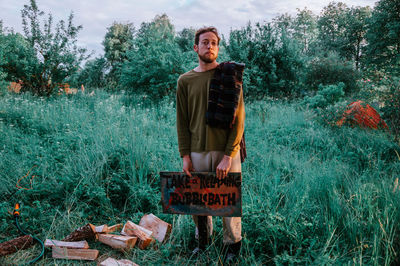 Portrait of young man standing on field