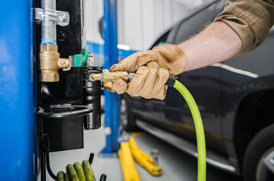 Cropped hand of man repairing car