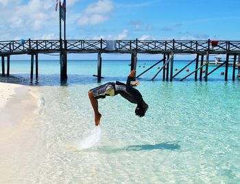 Woman jumping in sea