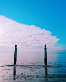 Lighthouse by sea against sky