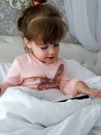 Cute girl relaxing on bed at home