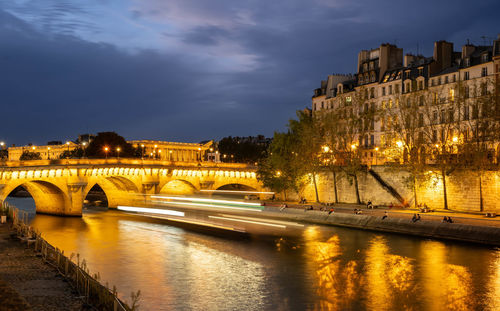 Bridge over river against sky at sunset