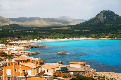 High angle view of sea and mountains against sky