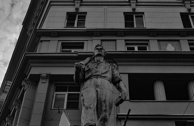 Low angle view of statue against building in city