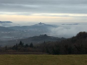 Scenic view of landscape against cloudy sky